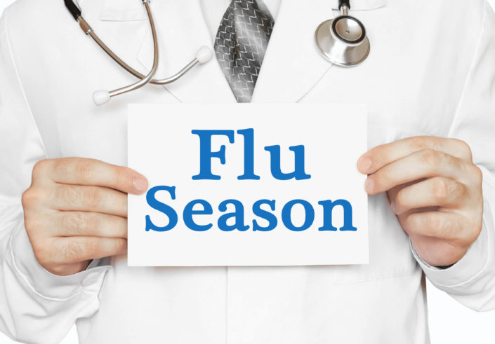 Doctor holding a card with Flu Season, medical concept