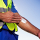 outdoor worker putting on sunscreen